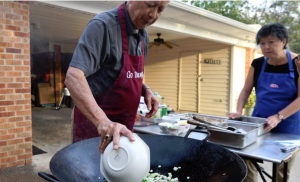 Gilroy and Sally Chow cooking great Chinese food (don't you want some too?).