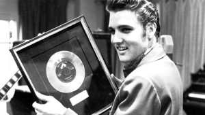 Elvis with his first gold record, "Heatbreak Hotel".