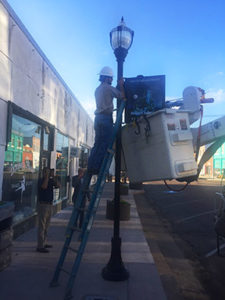 First sign prototype of Robert Johnson being hung by Clarkdale Public Utilities (photo by Richard Bolen).