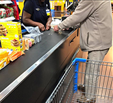 Clarksdale Walmart employee, Tracy Connor, helps an elderly gentleman out.