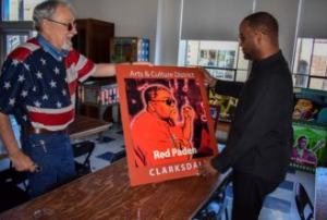 Mac Crank (left) and State Rep. Orlando Paden, D-Clarksdale, view a sign remembering Paden’s father, Red Paden of the renowned Red’s Lounge.