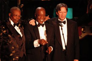 1987 inductee B.B. King and Eric Clapton lead Buddy Guy into the Rock and Roll Hall of Fame.