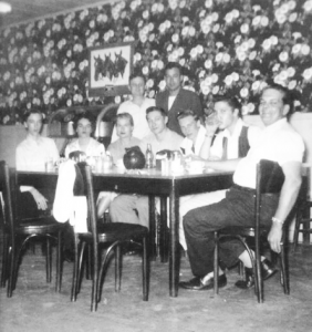 Gene Smith, Betty Amos, Helen (Neal) Hobgood, Scotty, Charles Neal, Elvis and Bob Neal with Jimmy Work and Bill Black standing in a cafe in Clarksdale, MS - Mar. 10, 195.5 (Photo source A. Fernándes).